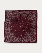 Lescarf Paisley Scarf in Wine Red, flat lay showing the white paisley print and border on wine red silk