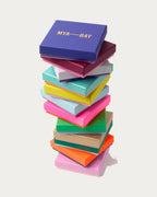 Stack of colourful MYA—BAY gift boxes, each piece arrives in a branded gift box