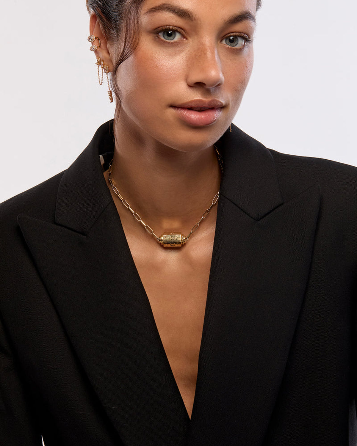 Model wearing the MYA—BAY Martinique Necklace in gold with a black blazer