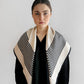 No.1 in Sand scarf by Lescarf worn around the neck with the striped points falling to the front over a black shirt