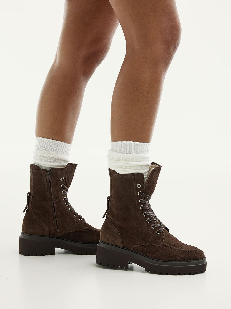 NUBIKK Fae Bobbi Fur boot in dark brown suede, styled on model with legs shown