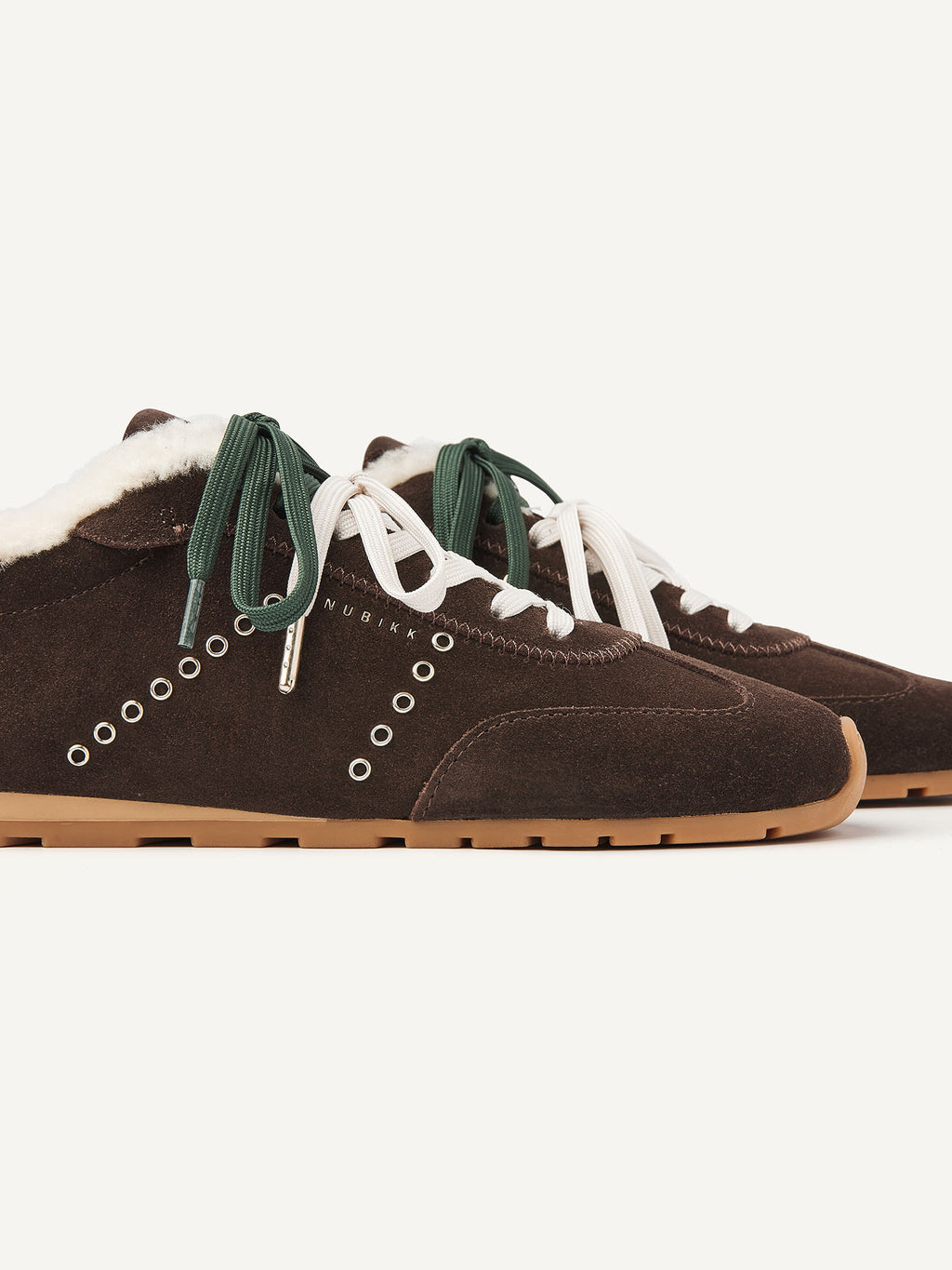 Close-up of the NUBIKK Billy Lou Fur sneaker with eyelet detail and green laces