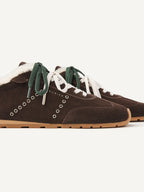 Close-up of the NUBIKK Billy Lou Fur sneaker with eyelet detail and green laces