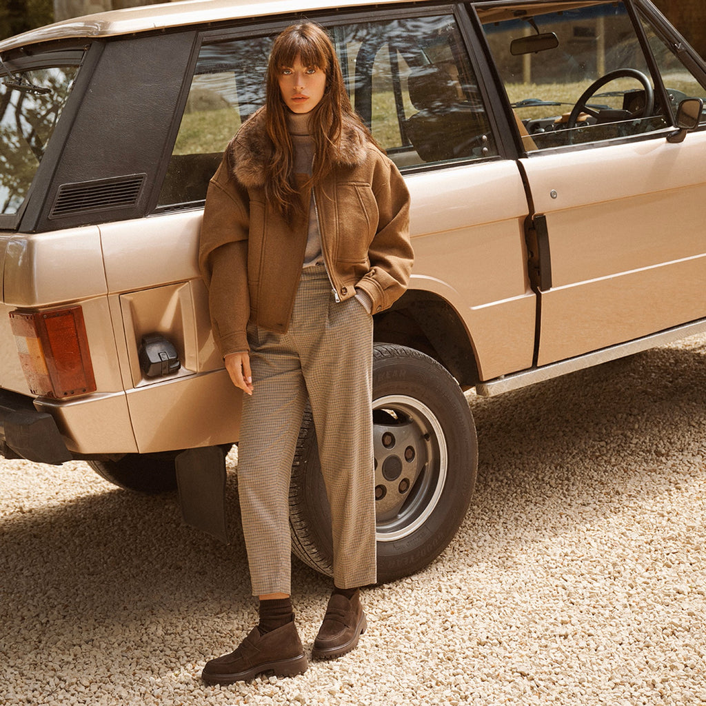 Model wearing the Paul Green Mocca Suede Loafer Boot with a camel jacket beside a vintage car