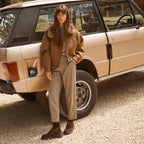 Model wearing the Paul Green Mocca Suede Loafer Boot with a camel jacket beside a vintage car