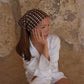 Polkadot Scarf in Brown by Lescarf worn as a headscarf with a white shirt