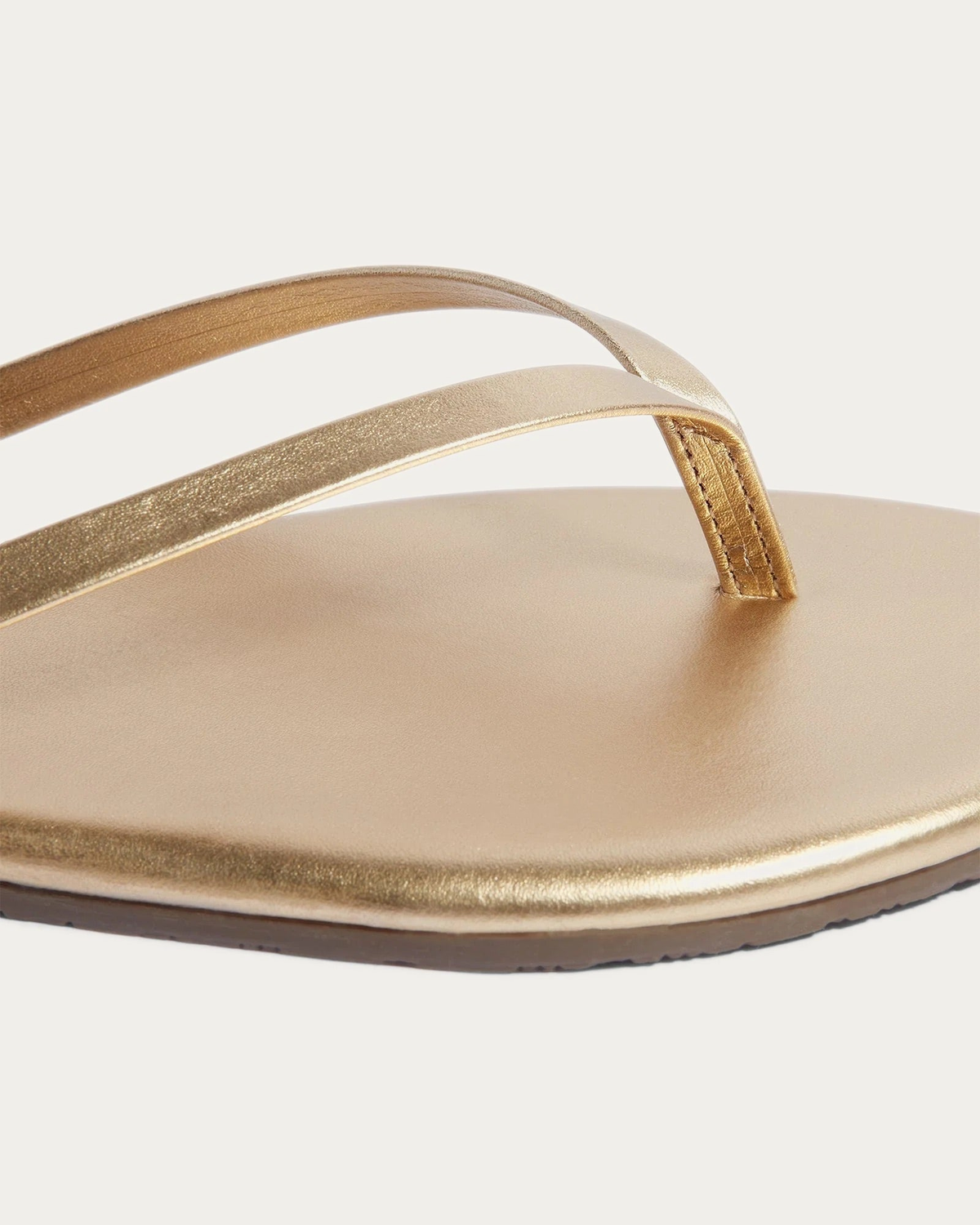 TKEES Metallics Blink Gold Leather Flip Flop, close-up of the straps and footbed