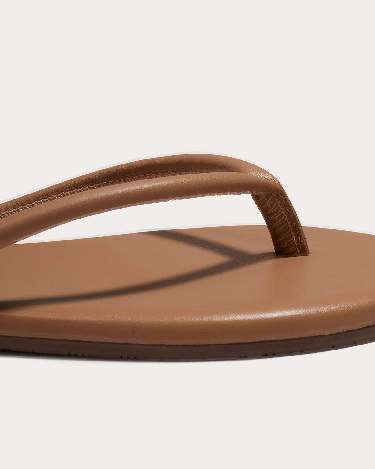 TKEES Tubular Lilly Cocobutter Ecru Flip Flop, close-up of the tubular strap and stitching