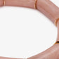 Close-up of the Flex Bracelet Blush Marble by Vanessa Baroni showing the tubular beads with gold discs