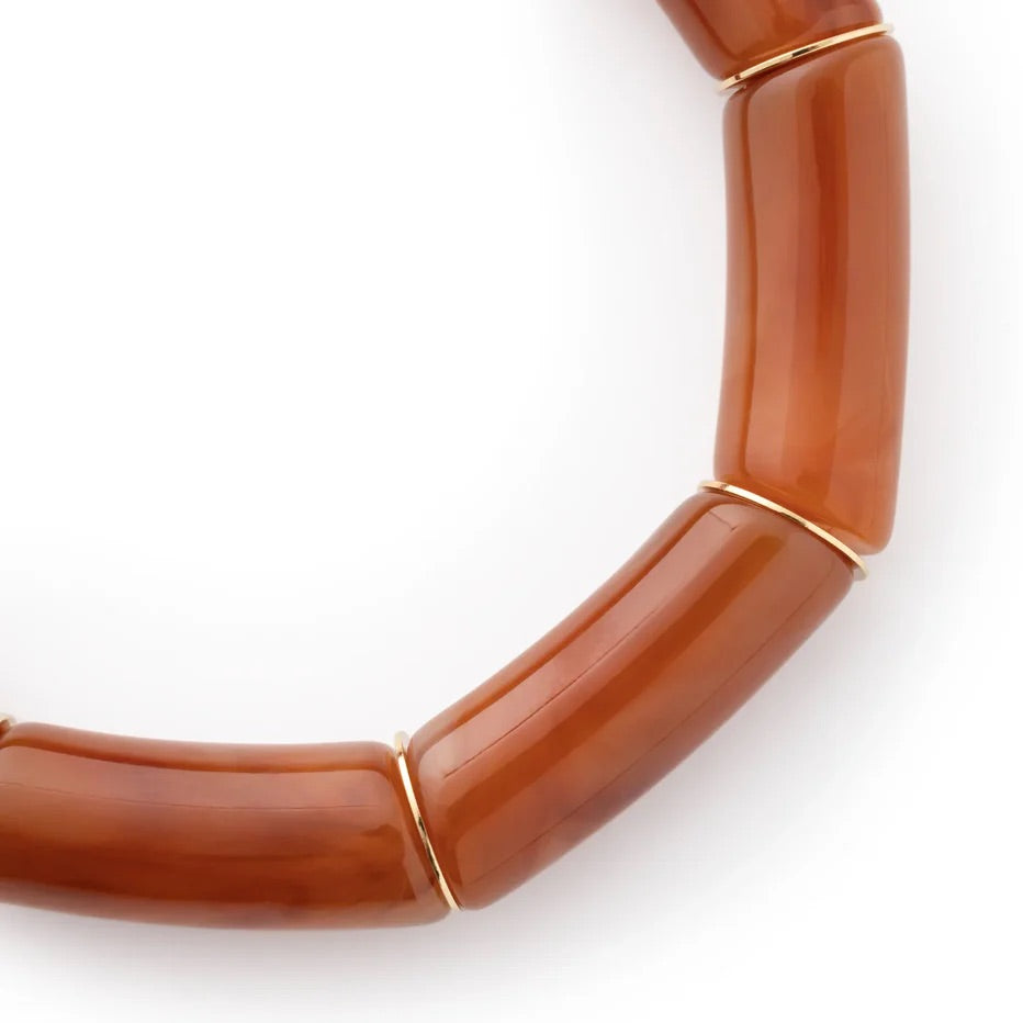 Close-up of the Flex Bracelet In Cognac Marble by Vanessa Baroni showing the tubular beads and gold discs