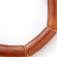Close-up of the Flex Bracelet In Cognac Marble by Vanessa Baroni showing the tubular beads and gold discs