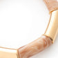 Close-up of the Flex Bracelet In Gold Creme Brulee by Vanessa Baroni showing the tubular beads and gold discs
