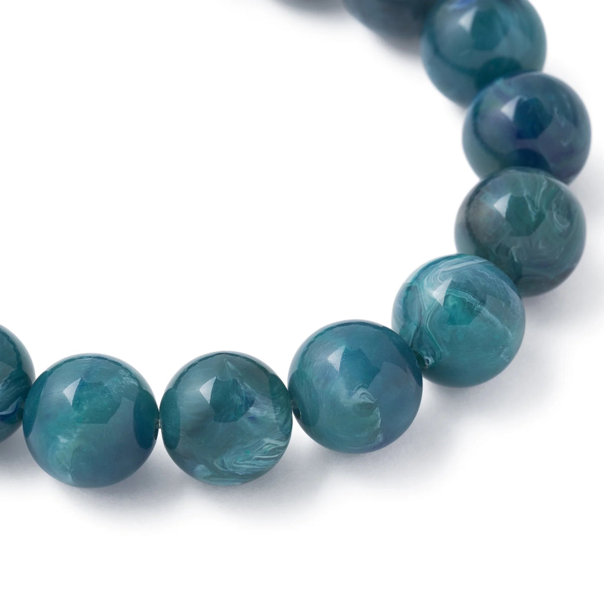 Close-up of the Mini Beads Flex Bracelet Teal Marble by Vanessa Baroni showing the round teal marble beads