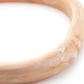 Close-up of the Soft Edge Bangle In Creme Brulee Marble by Vanessa Baroni showing the marbled finish of the bangle
