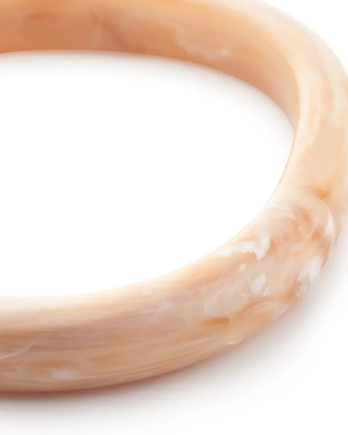 Close-up of the Soft Edge Bangle In Creme Brulee Marble by Vanessa Baroni showing the marbled finish of the bangle