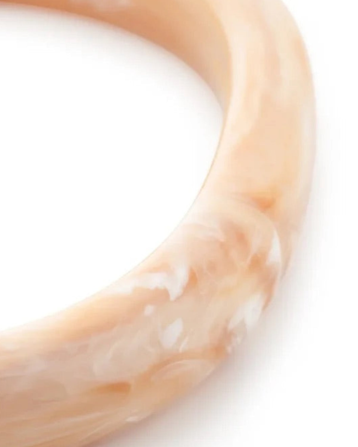 Close-up of the Soft Edge Bangle In Creme Brulee Marble by Vanessa Baroni showing the marbled finish of the bangle