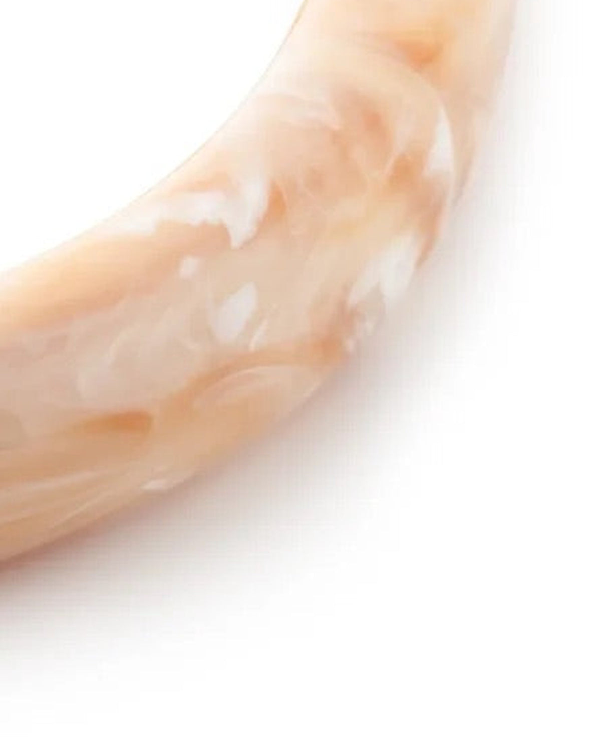 Close-up of the Soft Edge Bangle In Creme Brulee Marble by Vanessa Baroni showing the marbled finish of the bangle
