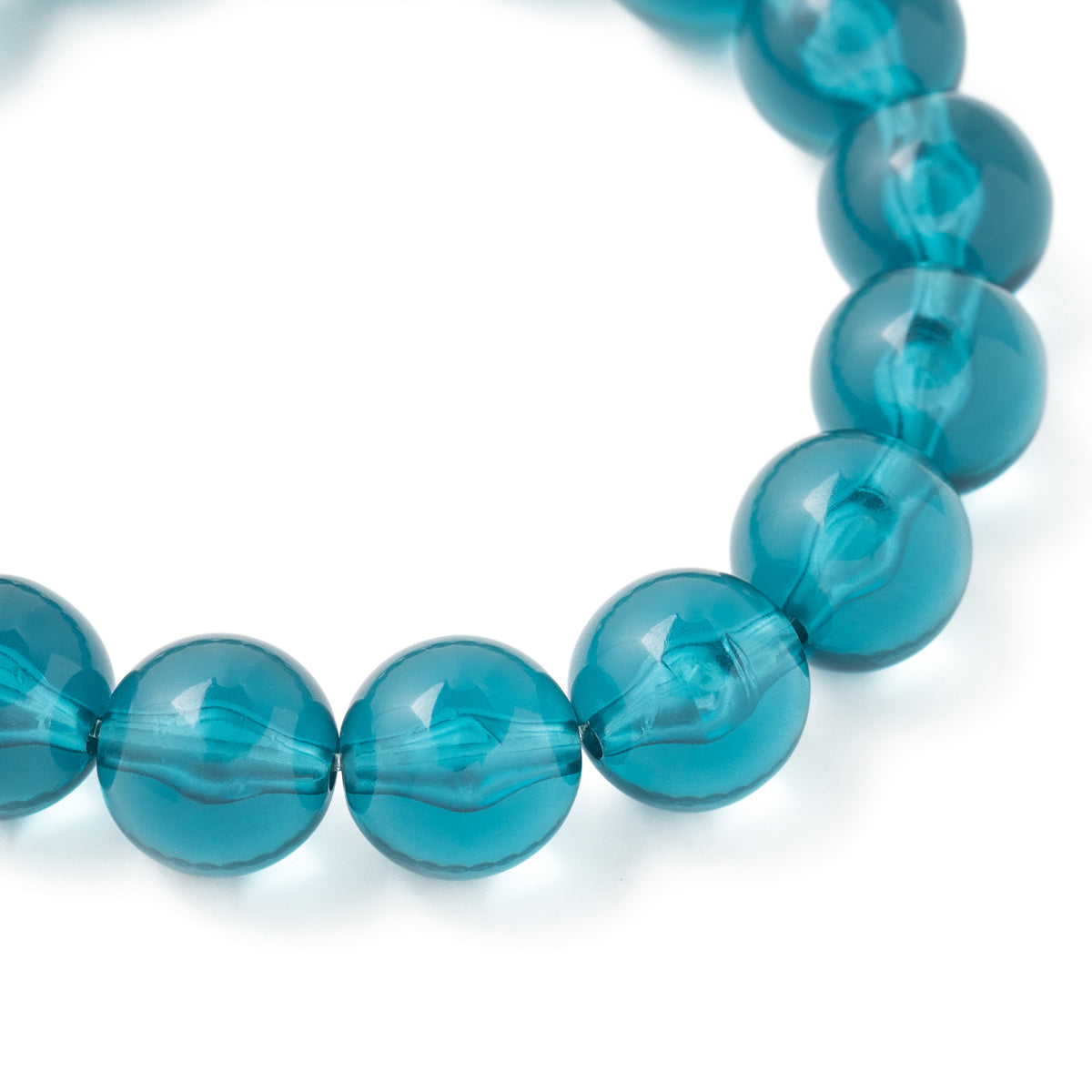 Close-up of the Mini Beads Flex Bracelet In Clear Teal by Vanessa Baroni showing the material and finish