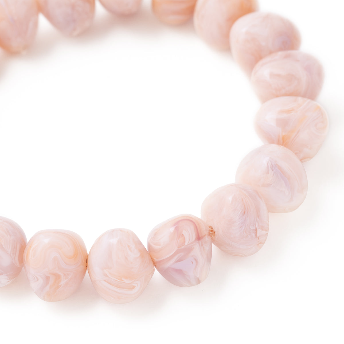 Close-up of the Mini Beads Flex Bracelet In Ivory Rose Marble by Vanessa Baroni showing the material and finish