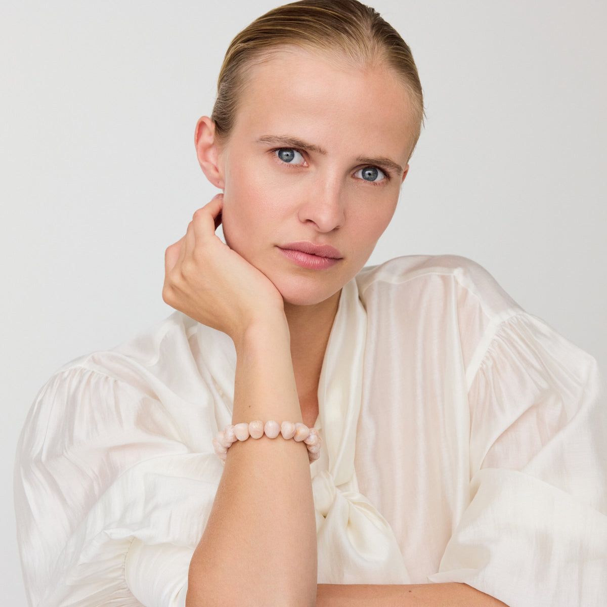 Mini Beads Flex Bracelet In Ivory Rose Marble by Vanessa Baroni, worn on a model's wrist