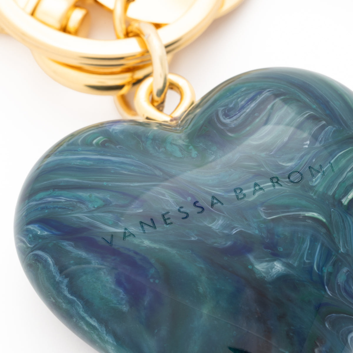 Close-up of the Heart Key Chain Charm In Teal Marble by Vanessa Baroni showing the material and finish