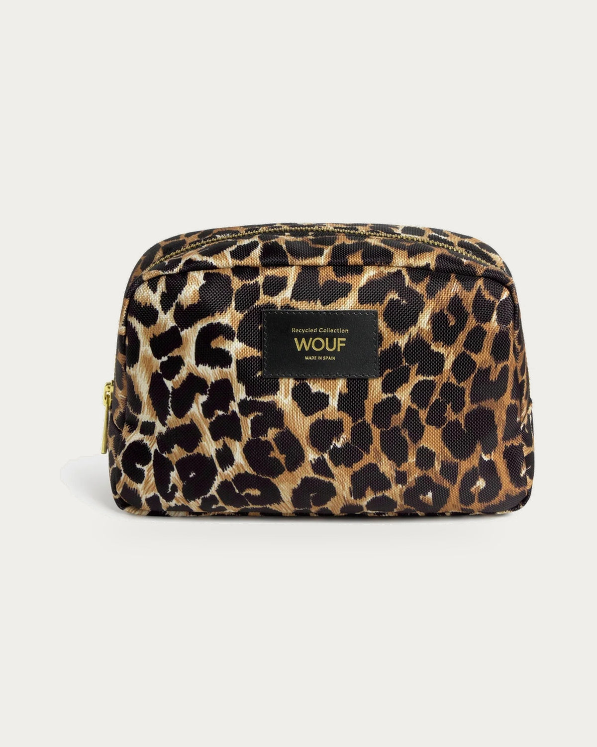 WOUF Icon Toiletry Bag in black and brown leopard print, front view with WOUF label and gold zip on soft stone background
