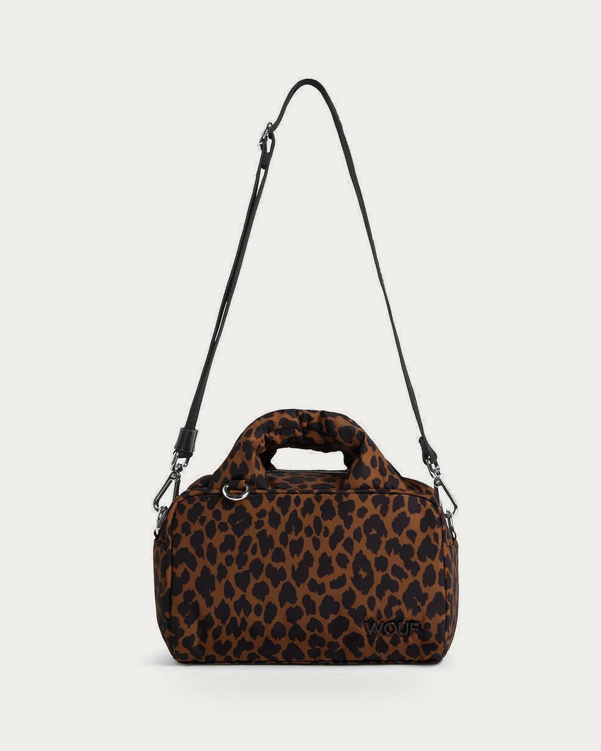 WOUF Leo Bowling Bag in brown and black animal print with crossbody strap, front view on soft stone background