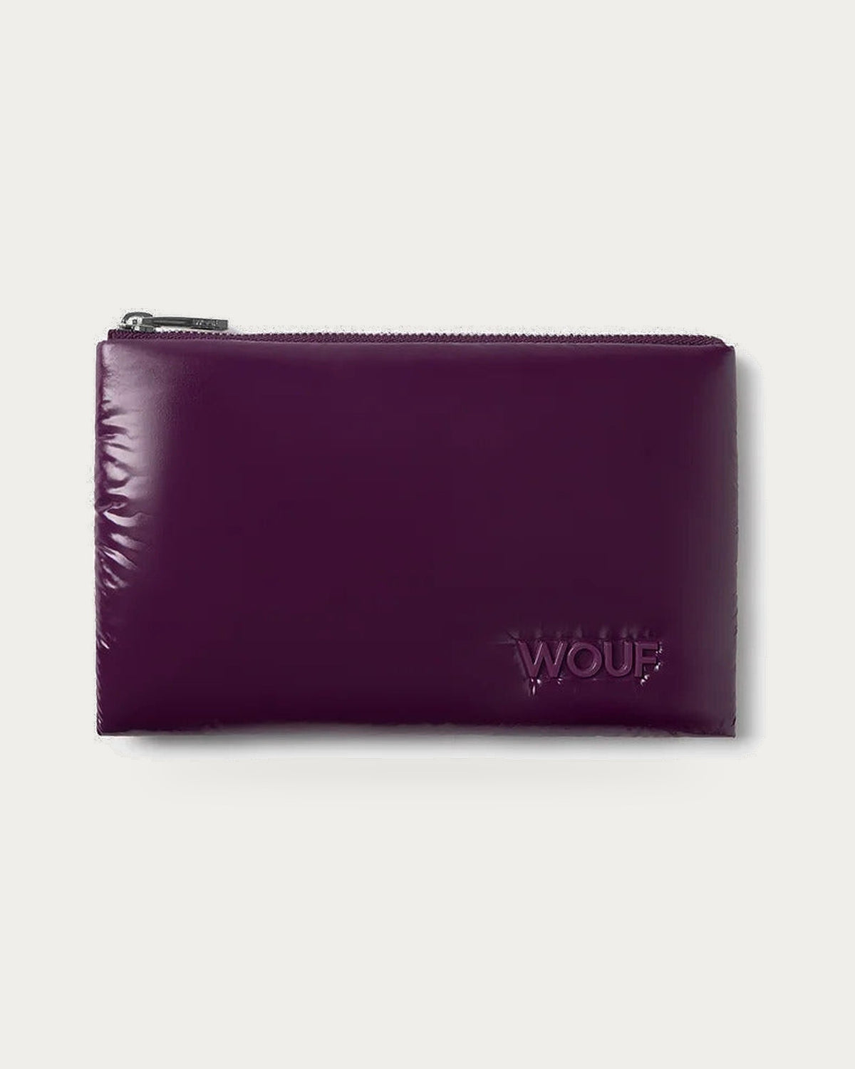 WOUF Plum Pouch in glossy plum recycled nylon with zip top, front view on soft stone background