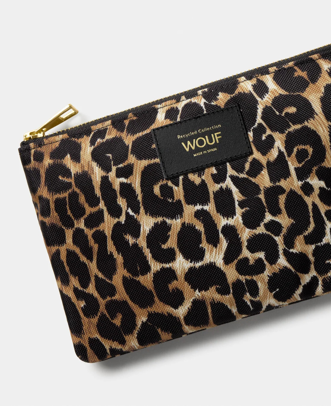 WOUF Icon Pouch close-up of black and brown leopard print with gold zip and WOUF label