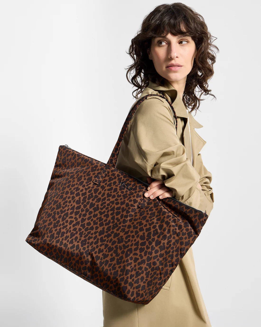 Model carrying the WOUF Leo Shopper Bag on the shoulder in brown and black animal print