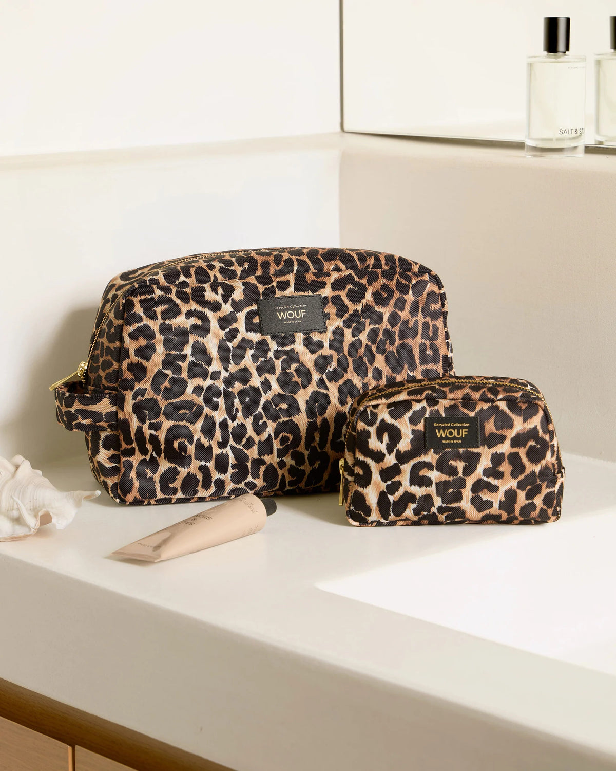 WOUF Icon Make Up Bag and toiletry bag in leopard print styled on a bathroom counter