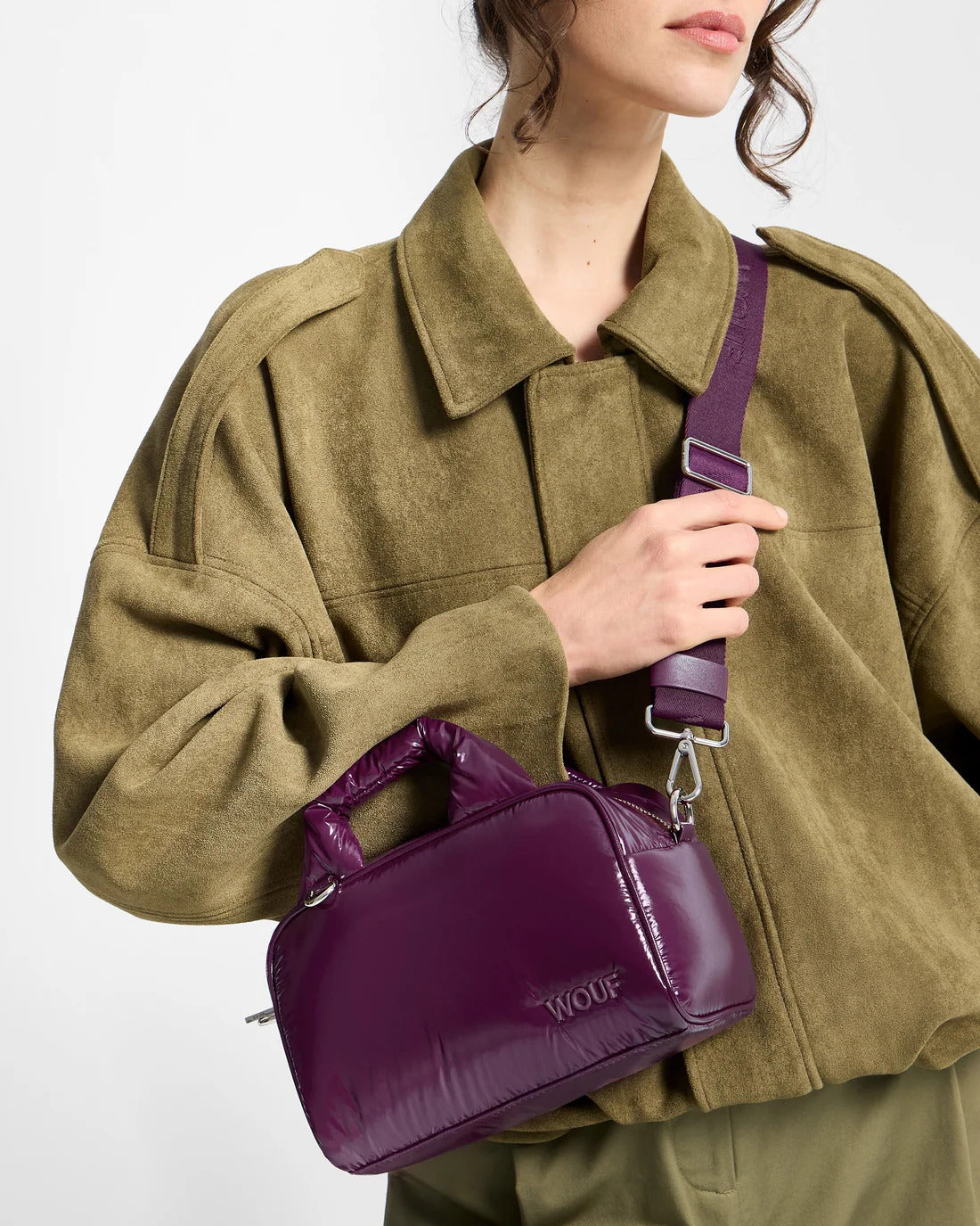Model wearing the WOUF Plum Bowling Bag across the body