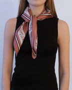 Zodiac Scarf Gemini in Terracotta by Lescarf knotted at the neck and worn with a black sleeveless top