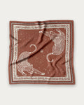 Zodiac Scarf Gemini in Terracotta by Lescarf, 65x65 cm, laid flat in terracotta with cream leopards, stars and a leopard-print border