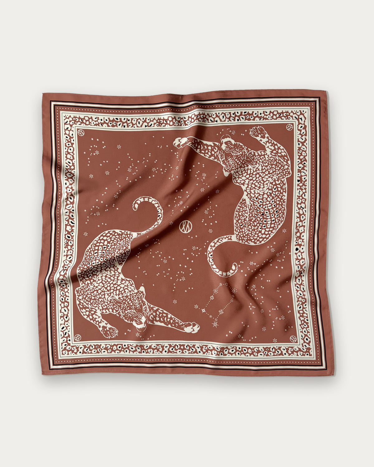 Zodiac Scarf Gemini in Terracotta by Lescarf, 65x65 cm, laid flat in terracotta with cream leopards, stars and a leopard-print border